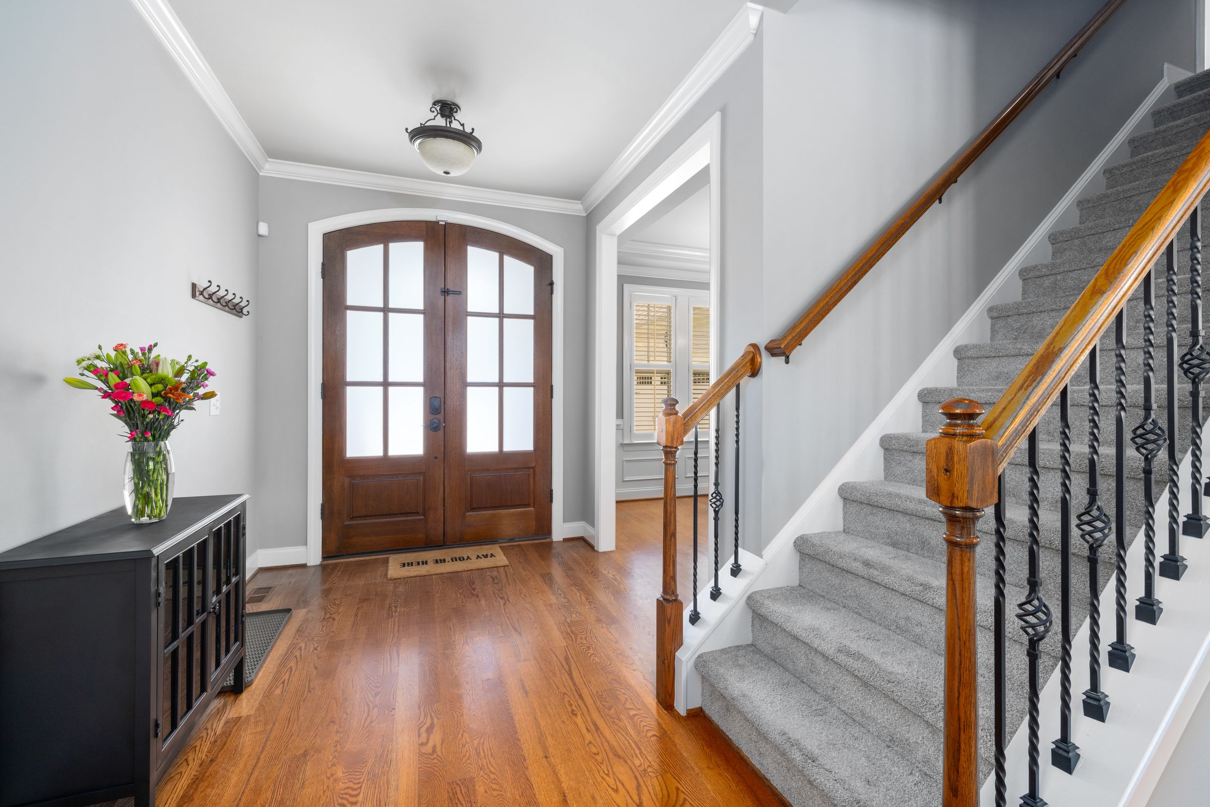 Home entryway with staircase and natural light